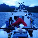 Jordan preparing meal at dusk off McKay Island